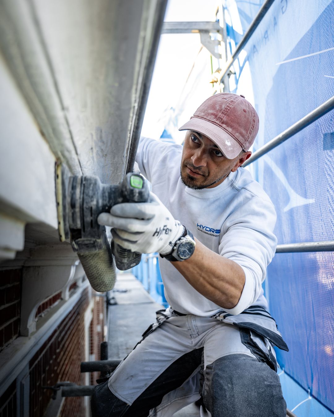 Residentie Raamweg met steiger en blauw gaas en fietser tijdens betonreparatie in Den Haag