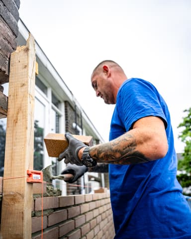 Detail van steen plaatsen in mortel bij metselen tijdens betonreparatie in Rotterdam door Hydro Groep